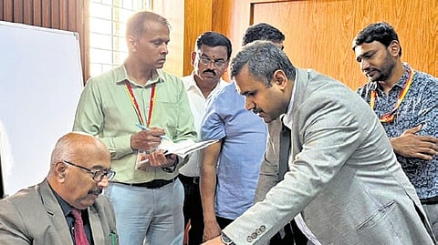 Upa Lokayukta Justice K N Phaneendra and his team verify records at an RTO office in the city on Friday.