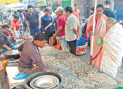 People buy fish at a market in Cuttack’s Seminary square