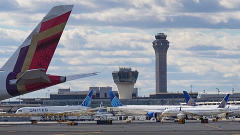 Planes taxi in front of an air traffic control tower at Newark International Airport in Newark, N.J., Thursday, Nov. 6, 2025.