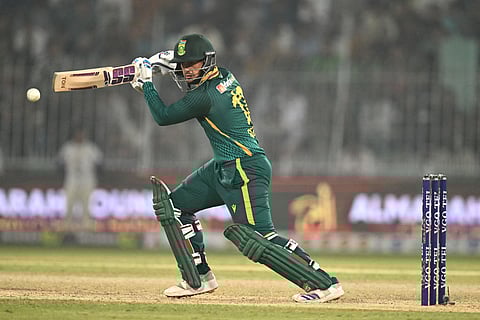 South Africa's Quinton de Kock plays a shot during the second one-day international (ODI) cricket match between Pakistan and South Africa at the Iqbal Stadium in Faisalabad on November 6, 2025.