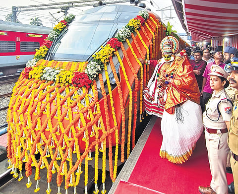 Artists dressed up in kathakali costumes pose in front of Ernakulam Jn-KSR B’luru Vande Bharat Express ahead of its inaugural journey from Kochi