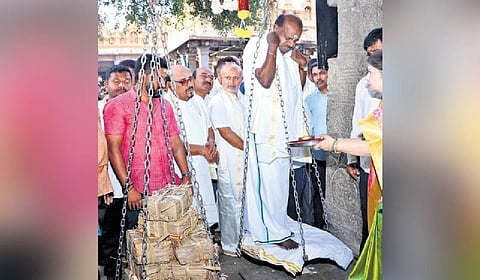 Union Minister HD Kumaraswamy offers thulabara at Nanjangud temple on Friday.