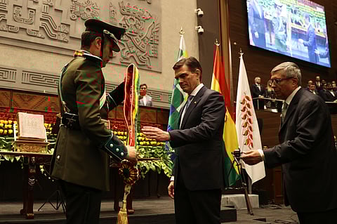 President Rodrigo Paz, right, receives the presidential sash from Vice President Edman Lara in La Paz, Bolivia, Saturday, Nov. 8, 2025.