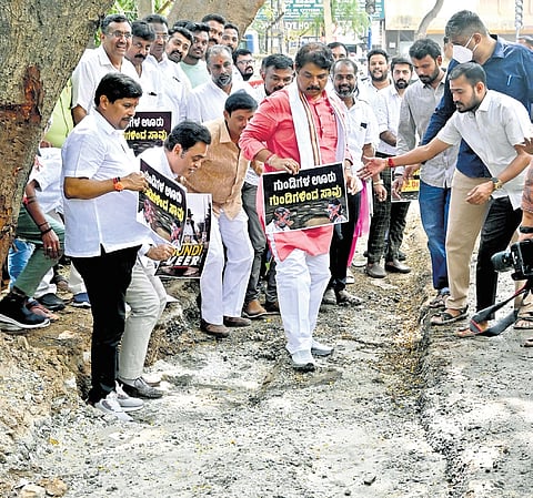 Opposition leader in the Assembly R Ashoka with other BJP leaders protest against the state government in Bengaluru on Saturday.