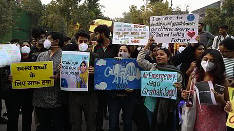 Activist protest against the government to air pollution at India Gate in New Delhi on Sunday