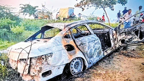 Mangled remains of the car which caught fire on the Tiruthuraipoondi bypass road on Sunday