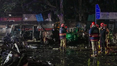 Firefighters at the spot after a blast occurred in a parked car near Red Fort, leaving multiple vehicles in flames, in New Delhi, Monday, Nov. 10, 2025.
