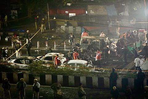 Security officials inspect the scene of a car explosion near the historic Red Fort in New Delhi, India, Monday, Nov. 10, 2025.
