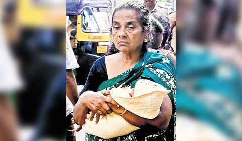 Moly, mother-in-law of Sivapriya, with the newborn baby during the protest outside the SAT Hospital on Sunday.
