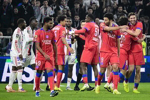 PSG's teammates celebrate after winning the French L1 football match between Olympique Lyonnais (OL) and PSG in Decines-Charpieu, central-eastern France, on November 9, 2025.