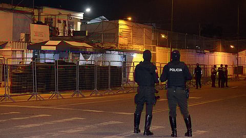 Police officers stand guard at the entrance of the prison in Machala, Ecuador on November 9, 2025.