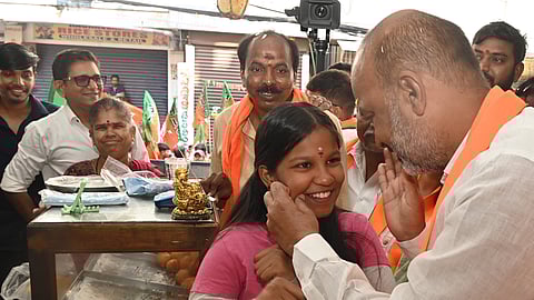 Union Minister of State for Home Affairs Bandi Sanjay Kumar takes part in a door to door campaign in support of the BJP candidate at Krishnanagar on Sunday.