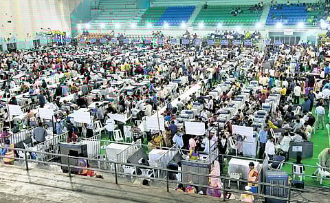 Polling officials collect ballot boxes at the Kotla Vijaya Bhaskar Reddy Stadium at Yousufguda on Monday.