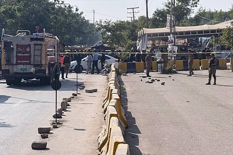 Pakistani security officials stand guard after a powerful car bomb exploded outside a district court in Islamabad, Pakistan, Tuesday, Nov 11, 2025