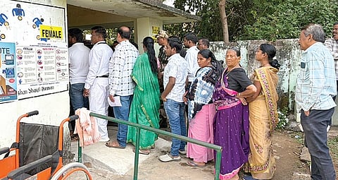 Voters line up at a booth in Nuapada to exercise their franchise, on Tuesday