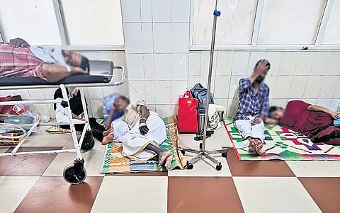 With no beds left inside, patients and bystanders crowd the verandas of the Kozhikode Government Medical College, seeking space and medical attention.