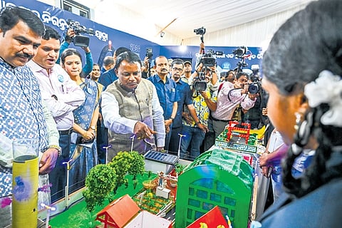CM Mohan Majhi speaks to students on their project after inaugurating the state-level children’s festival ‘Suravi 2025’ in Bhubaneswar on Wednesday.