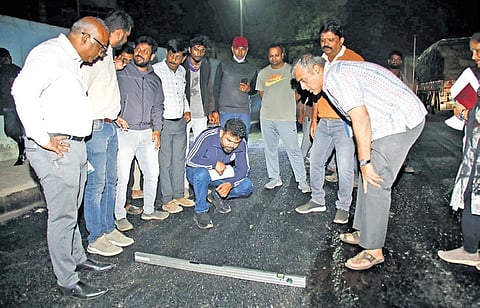 GBA Chief Commissioner M Maheshwar Rao (right) looks at a road, during a late-night inspection he undertook, in Bengaluru late on Tuesday.