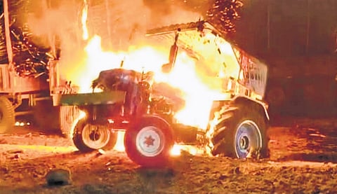 One of the sugarcane-laden tractors set on fire outside Godavari factory in Mudhol taluk of Bagalkot district on Thursday