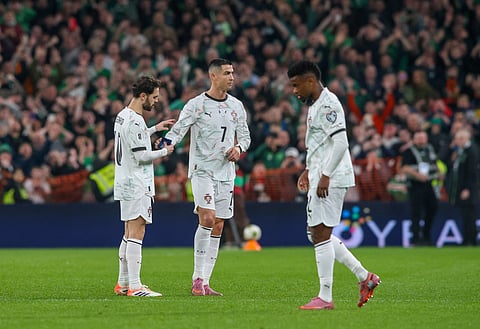Cristiano Ronaldo hands the captain's armband to Portugal's midfielder Bernardo Silva (L) as he leaves the pitch after receiving a second yellow card during the men's football 2026 World Cup Group F qualifier between Ireland and Portugal on November 13, 2025.