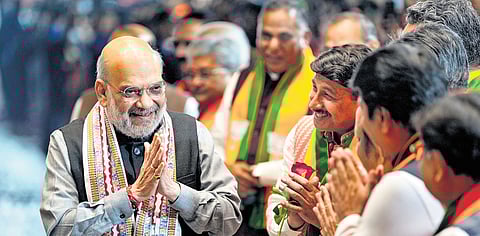 Amit Shah being greeted by BJP MP Manoj Tiwari and others during victory celebrations at BJP headquarters in Delhi.