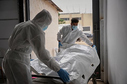 Bodies of unidentified Palestinians returned from Israel as part of the ceasefire deal are brought to Nasser Hospital in Khan Younis, Gaza Strip, Friday, Nov. 14, 2025.