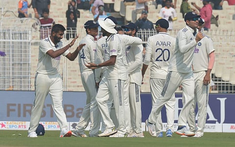 India's Jasprit Bumrah (L) celebrates with teammates after taking the wicket of South Africa's Ryan Rickelton during the first day of the first Test cricket match between India and South Africa, at the Eden Gardens, in Kolkata, Friday, Nov. 14, 2025.