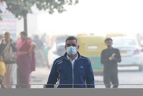 A man wears a mask amid smog in New Delhi.