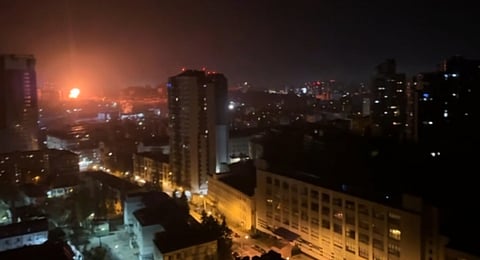In this image taken from video, an explosion is seen in the distance as a Russian attack targets Ukraine's Kyiv region on Friday, Nov. 14, 2025.