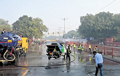 MCD workers clean the spot where a blast took place near the Red Fort.
