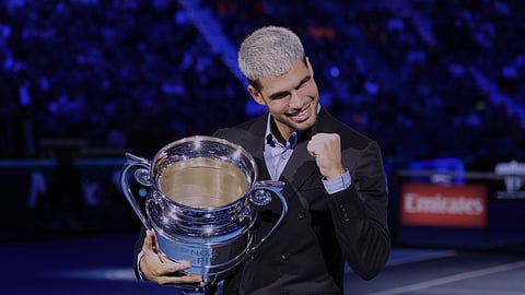 Spain's Carlos Alcaraz holds the trophy for finishing the year ranked No. 1 as ATP world best player during the ATP World Tour Finals, in Turin, Italy, Friday, Nov. 14, 2025.