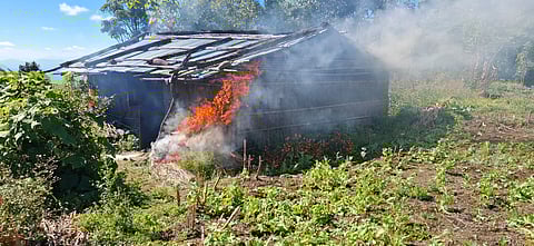 Security personnel burn huts while clearing poppy plantations.
