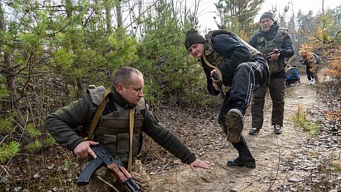 Civilians practice military skills on a training ground in Kharkiv region, Ukraine, Saturday, Nov. 15, 2025.