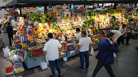 Sellers prepare vegetables for customers at the Dorogomilovsky market in Moscow, Russia, Sept. 13, 2024.