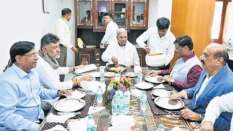 Chief Minister Siddaramaiah, Deputy CM DK Shivakumar and other ministers and legislators relish ragi mudde at Karnataka Bhavan in New Delhi on Monday.