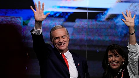 Presidential candidate Jose Antonio Kast of the Republican Party and his wife, Maria Pia Adriasola, wave to supporters after early results in the general elections in Santiago, Chile, Sunday, Nov. 16, 2025.