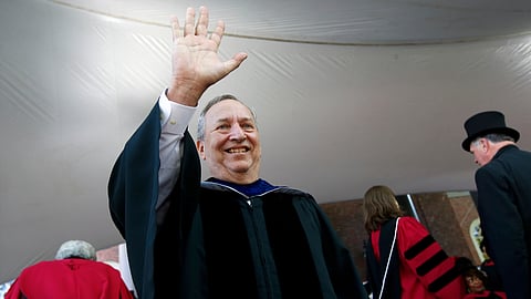 Former Harvard University president Larry Summers waves during Harvard commencement exercises, May 24, 2018, in Cambridge, Mass