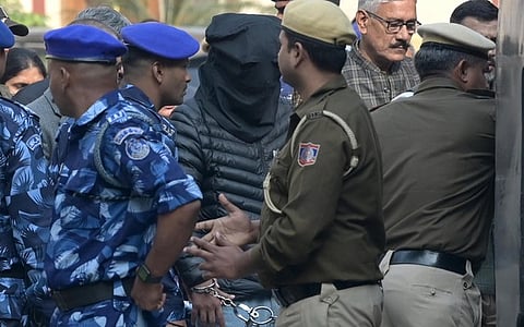 Jasir Bilal Wani, (face covered) a key accused in car bomb blast near Red Fort, brought to the Patiala House Court, in New Delhi.
