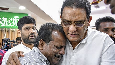 Telangana Minister of Minority Welfare Mohammad Azharuddin consoles a relative of a victim.