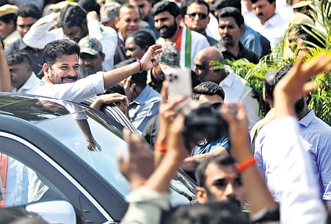 Chief Minister A Revanth Reddy greets the public during the launch of Indiramma saree distribution programme in Hyderabad on Wednesday