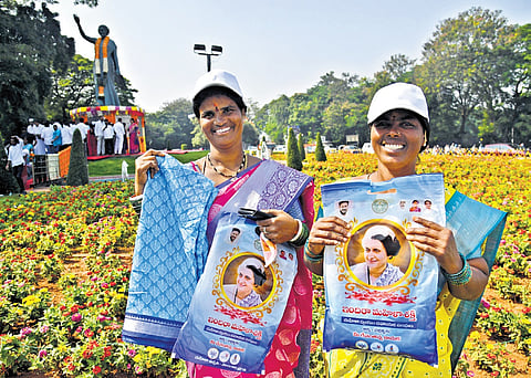 Beneficiaries express their joy after being handed over Indiramma sarees, in Hyderabad on Wednesday