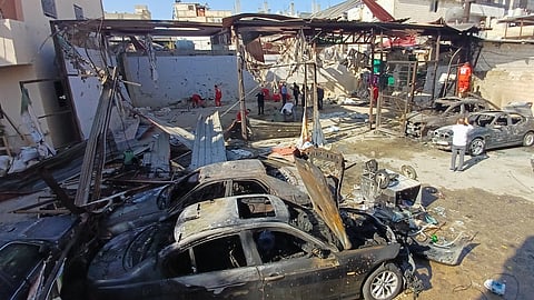 Palestinian rescue workers check the scene where an Israeli strike on Tuesday night hit the Ein el-Hilweh Palestinian refugee camp, in the southern port city of Sidon, Lebanon, Wednesday, Nov. 19, 2025.
