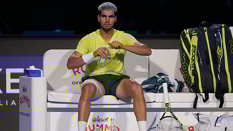 Spain's Carlos Alcaraz sits between the games during the final tennis match of the ATP World Tour Finals against Italy's Jannik Sinner, in Turin, Italy, Sunday, Nov. 16, 2025.