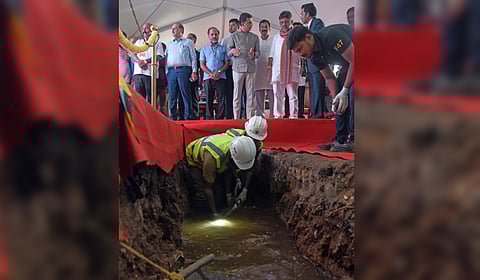 DY CM D K Shivakumar and BWSSB Chairman Ramprasat Manohar, having a look at a robotic device that enters into internal pipelines, helping detect water and sewage leakages as well as identify illegal connections.