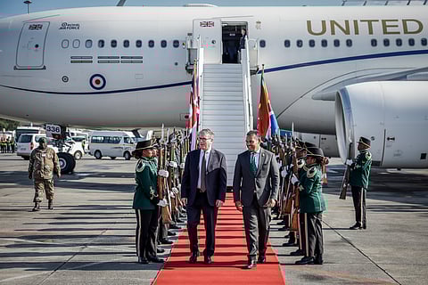 Britain's Prime Minister Keir Starmer, center left is welcomed by a South African representative upon his arrival at the OR Tambo International airport in Ekurhuleni on Friday, Nov. 21, 2025 ahead of the G20 leaders' Summit.