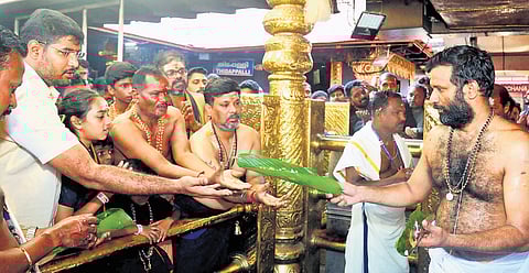 Sabarimala melsanthi Arun Kumar Namboothiri distributes prasadam to devotees