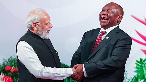 Prime Minister Narendra Modi being welcomed by South African President Cyril Ramaphosa upon his arrival to attend the G20 Leaders' Summit in Johannesburg. (Photo | PTI)