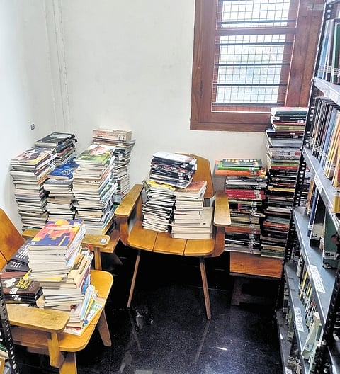 Books stacked on chairs at the State Central Library in Thiruvananthapuram