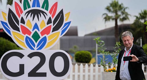 A journalist takes a selfie outside the media centre of the G20 Summit in Johannesburg, South Africa, Friday, Nov. 21, 2025.