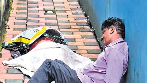 George sitting near the victim’s body in a dazed state in the courtyard of his house at Konthuruthy, Thevara